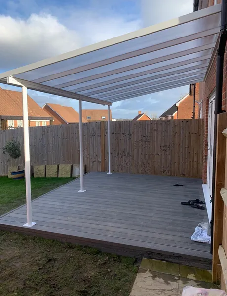 Composite decking beneath a polycarbonate-roofed veranda – decking and verandas for homes in Waterlooville
