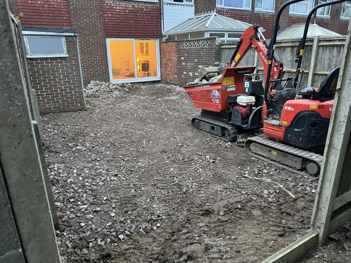Garden groundworks with a tracked dumper preparing a site, typical of what our builders in Horndean carry out