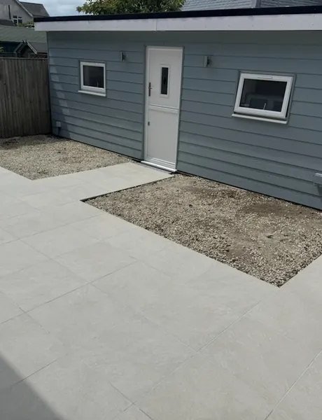 Porcelain patio laid beside a timber-clad garden room – patios for homes in Horndean