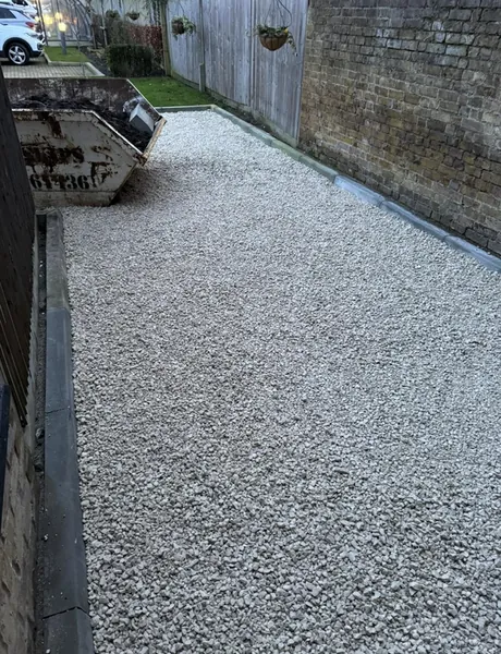 Gravel side path with edging and a skip on site – paths and driveways for homes in Emsworth