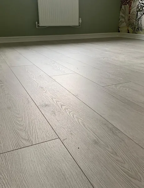Grey oak-effect laminate flooring laid in a bedroom – flooring for homes in Havant