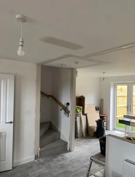 Open-plan ground floor being fitted out, with staircase and French doors – open-plan alterations for homes in Havant
