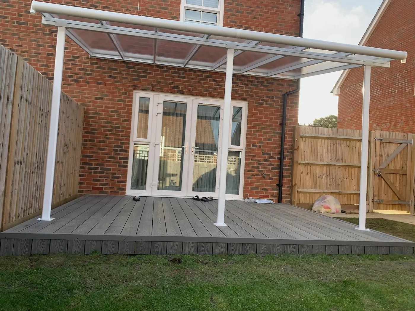 Veranda canopy over composite decking outside French doors, typical of work by our builders in Hayling Island